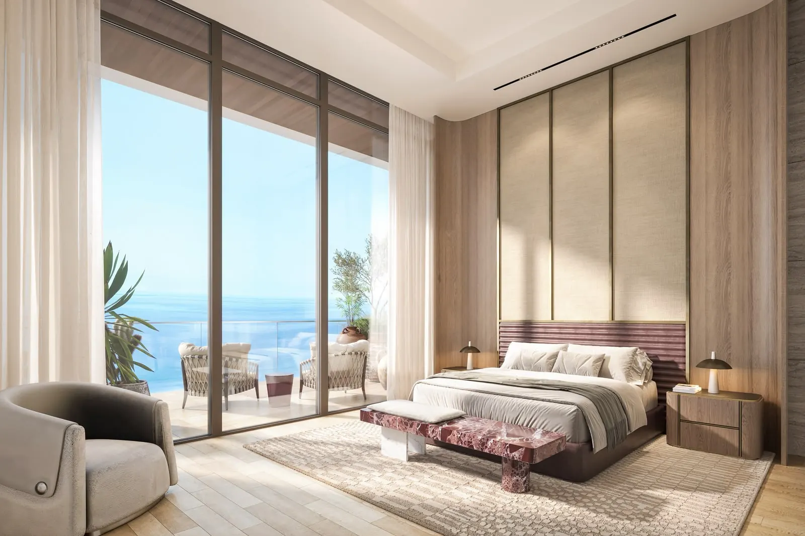 Principal bedroom with oak panelling, a red marble bench and full-height glass opening onto a sea-view terrace